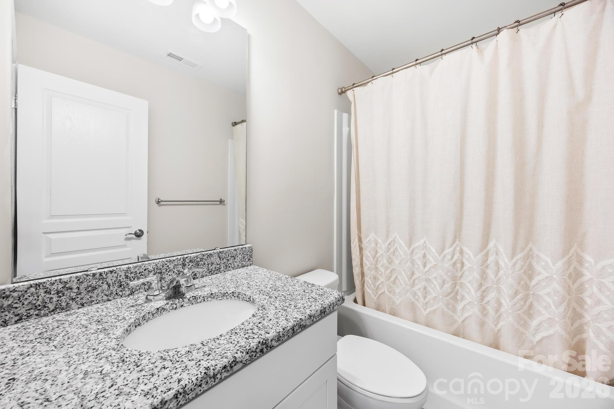 The upstairs guest bath is thoughtfully positioned to serve the secondary bedrooms with ease. - Charlotte
