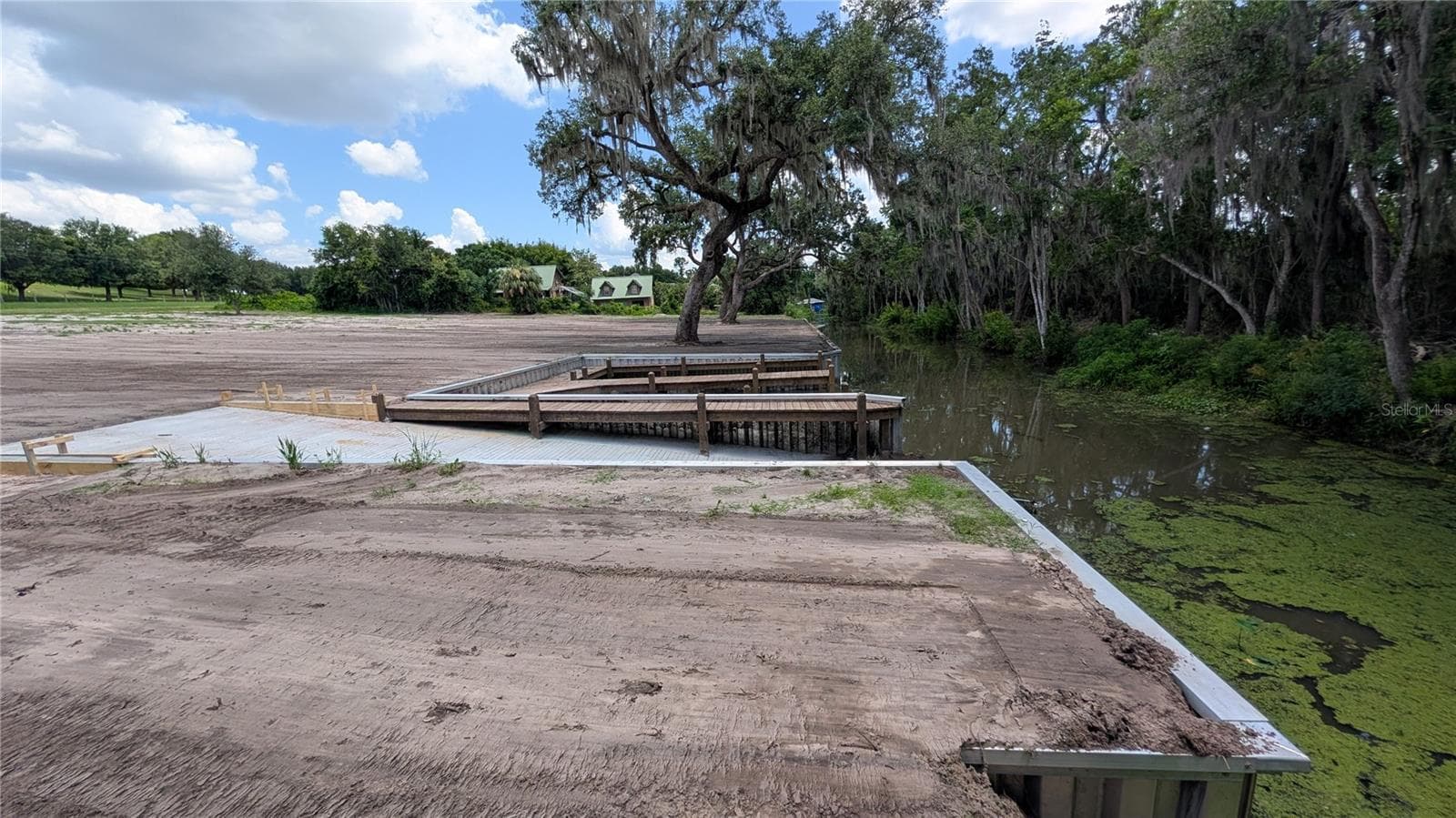 View of canal, boat ramp, dock, and cleared property from canal-side property corner - SULEN RD, LADY LAKE