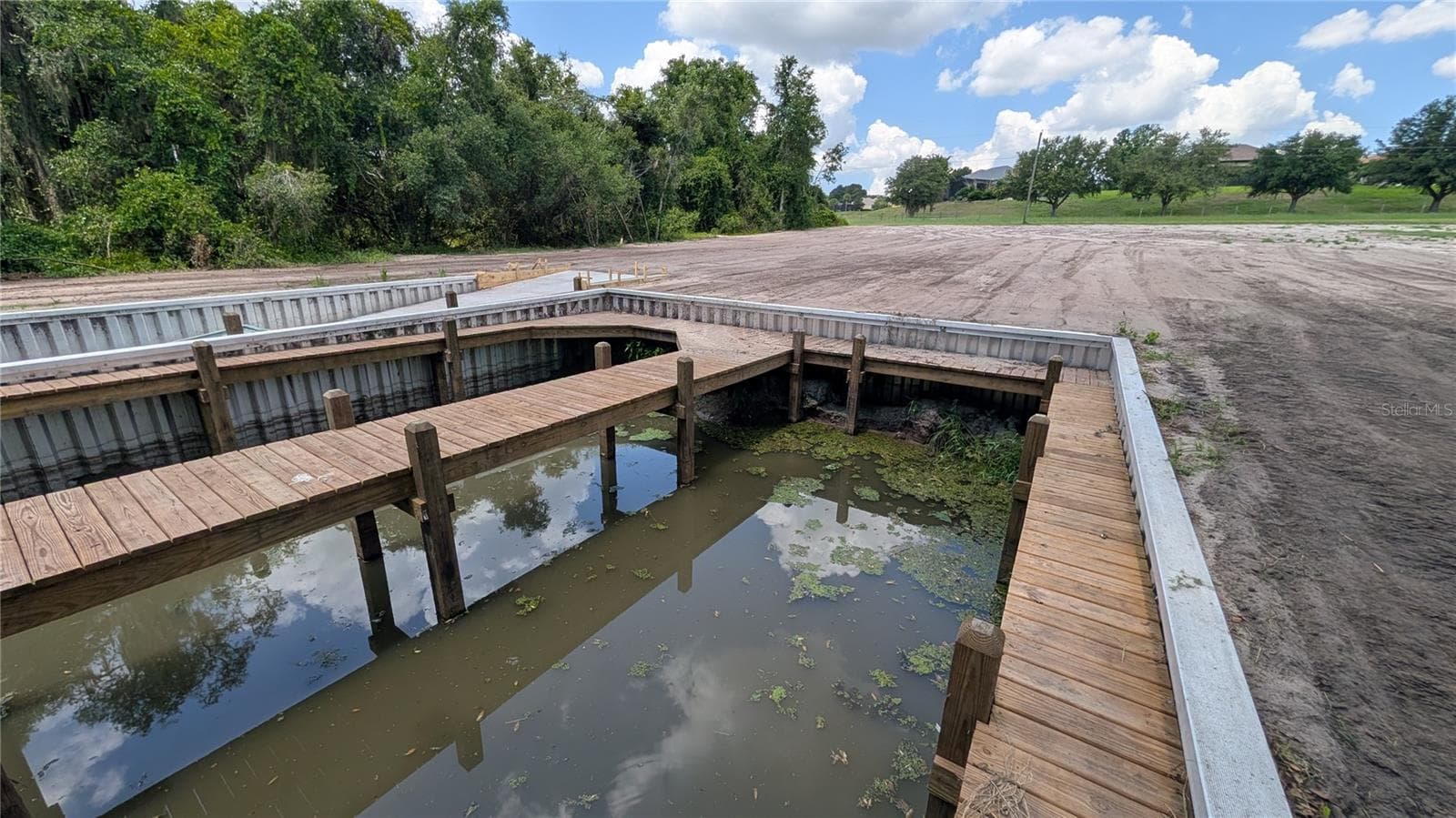 View of double boat dock and cleared property - SULEN RD, LADY LAKE