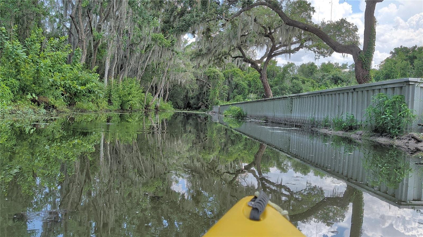 View from kayak in canal with retaining wall and property on the right - SULEN RD, LADY LAKE