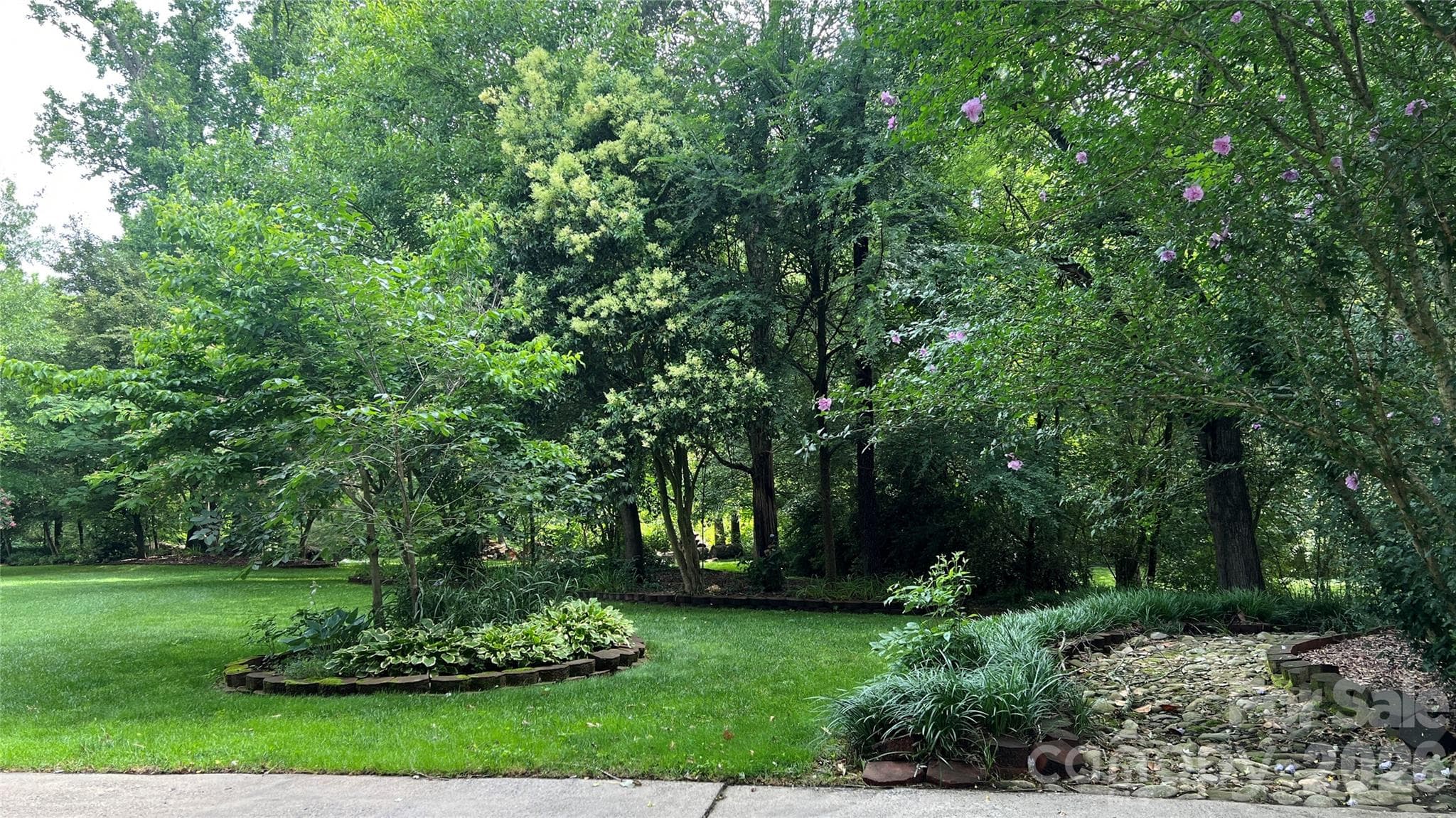 Side yard featuring a small stream and horseshoe area - Kings Mountain