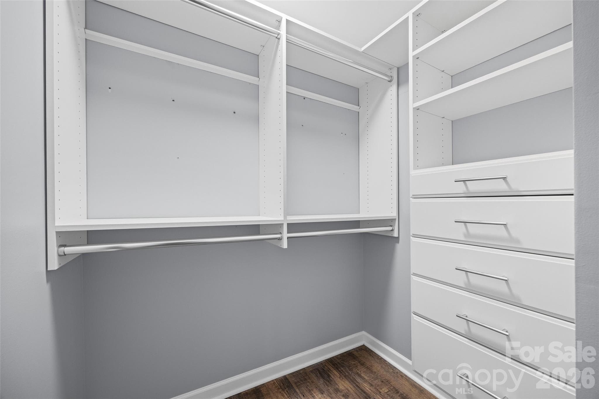 Primary Bedroom Walk In Closet with custom shelving - 8119 Tremaine Court, Charlotte