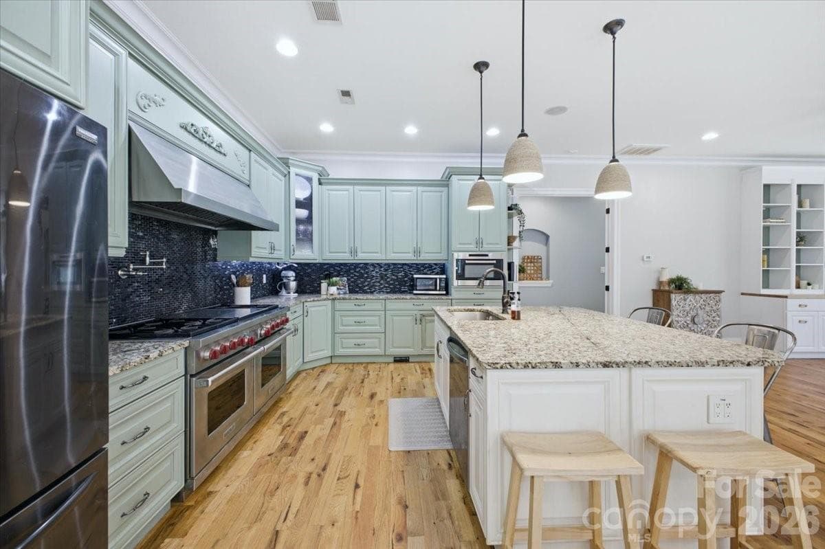 Gourmet kitchen featuring 60" Wolf gas range and double oven - Fort Mill