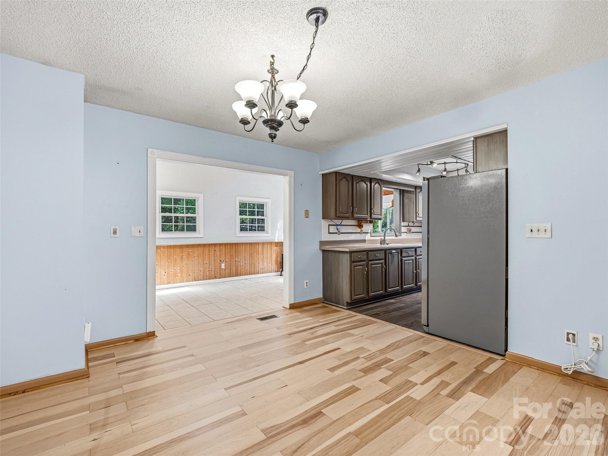 Open living and dining rooom with entrance to sunroom. - 206 Camellia Way, Laurel Park