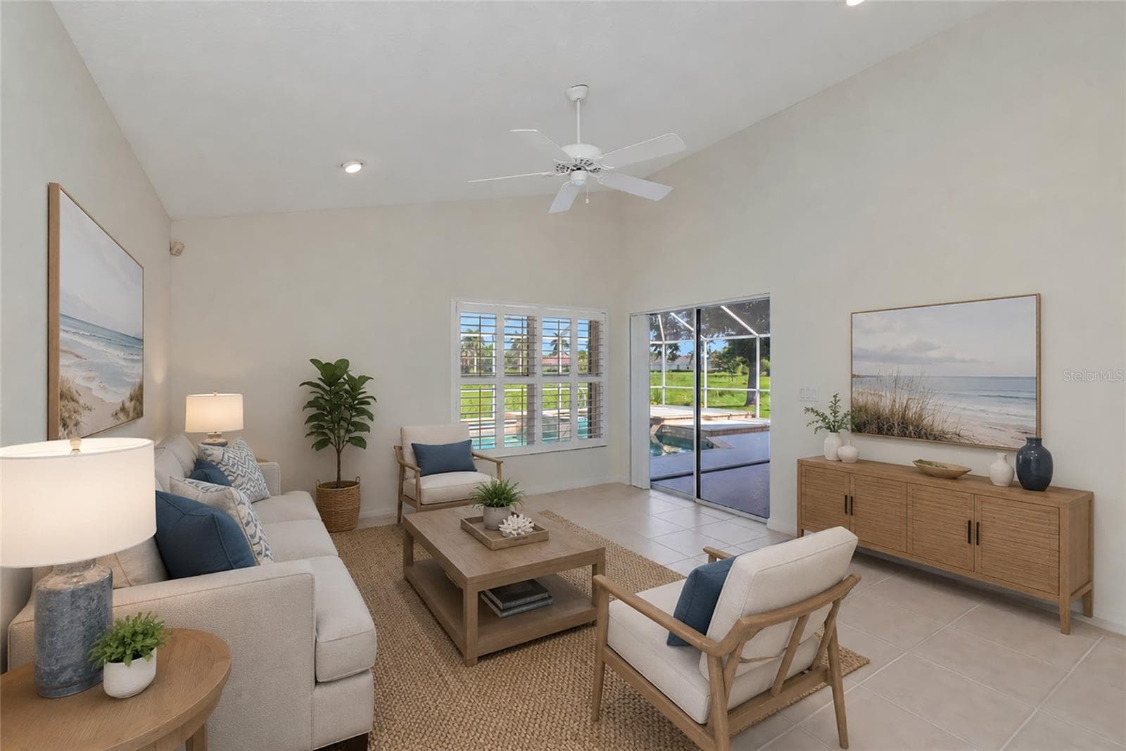 Virtual Staged. Family room open to kitchen with view of pool & spa. - 5133 FLAGSTONE DR, SARASOTA