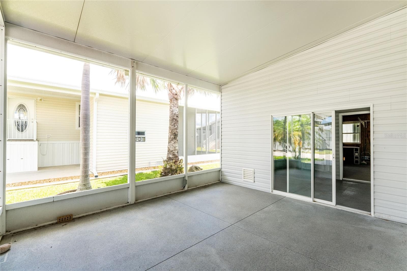 Screened porch which leads you to storage and wood working room - 10 HOLLAND DR, PUNTA GORDA