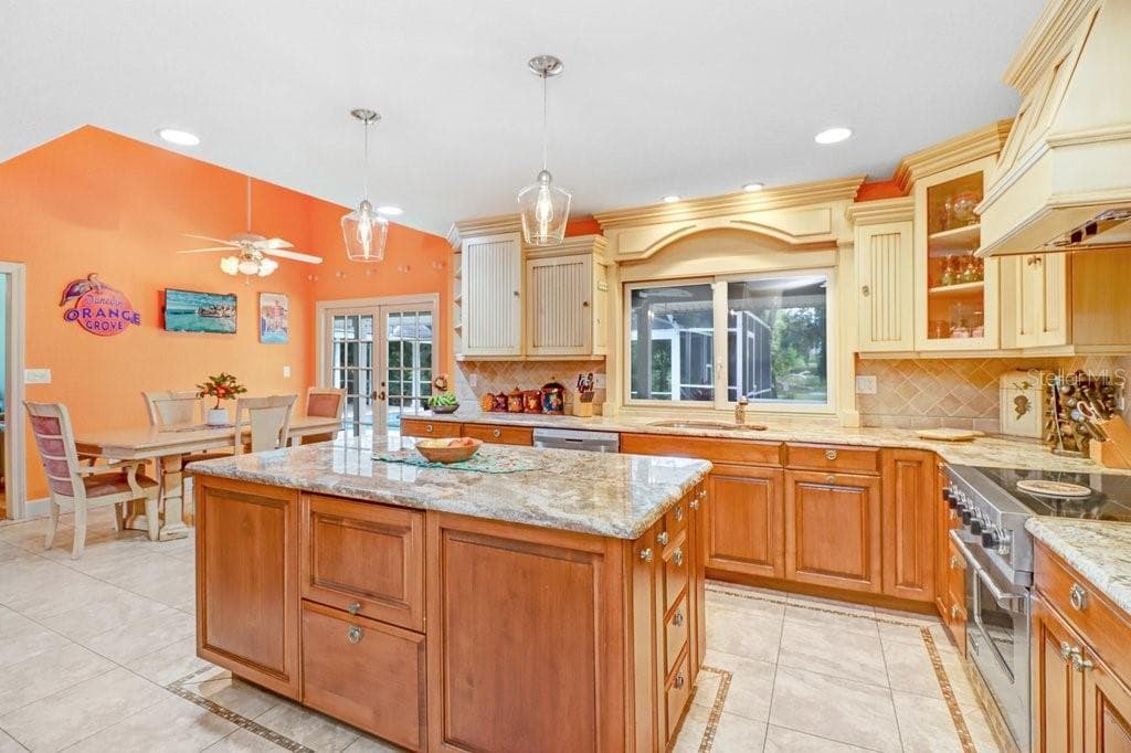 Kitchen island includes plenty of storage and built-in microwave. - 1976 DUNLOE CIR, DUNEDIN