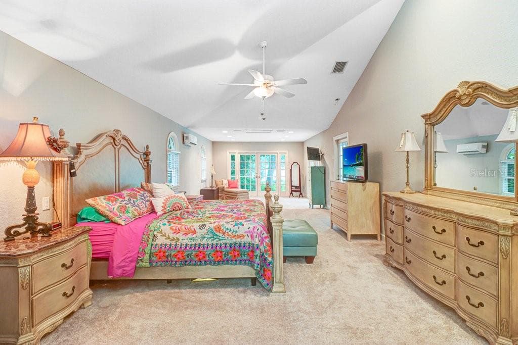Expansive master bedroom 14' x 37' with vaulted ceilings and large sitting area and french doors out to pool/patio area. - 1976 DUNLOE CIR, DUNEDIN