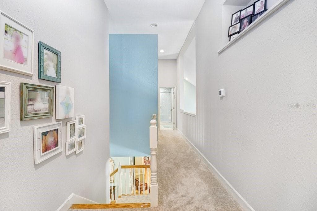 Hallway with pot shelves and open area to the Great Room - 1976 DUNLOE CIR, DUNEDIN