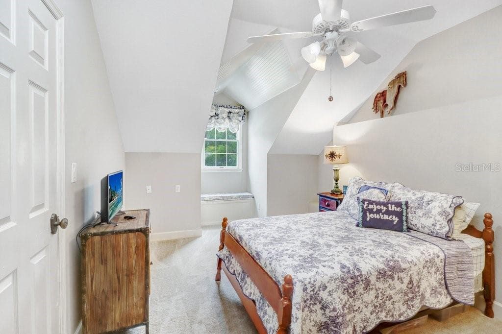 Large oversized guest room with window seat that has storage and walk in closet with vaulted ceilings. - 1976 DUNLOE CIR, DUNEDIN