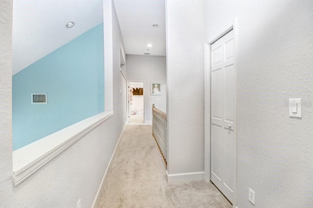 Open view to Great room below and hallway between upstairs bedrooms. - 1976 DUNLOE CIR, DUNEDIN