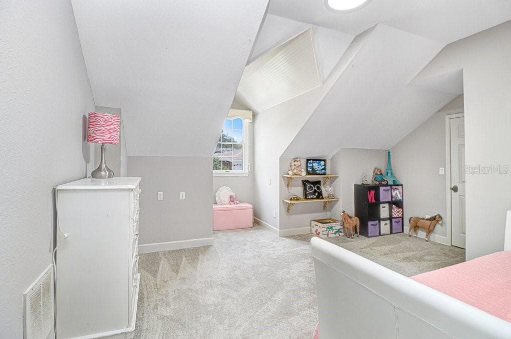 Another oversized bedroom with dormer window area and walk-in closet. - 1976 DUNLOE CIR, DUNEDIN