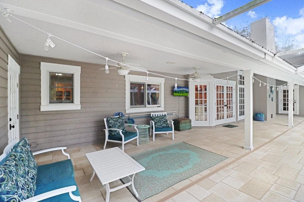 Another view highlighting the French doors around the entire back of the house. - 1976 DUNLOE CIR, DUNEDIN