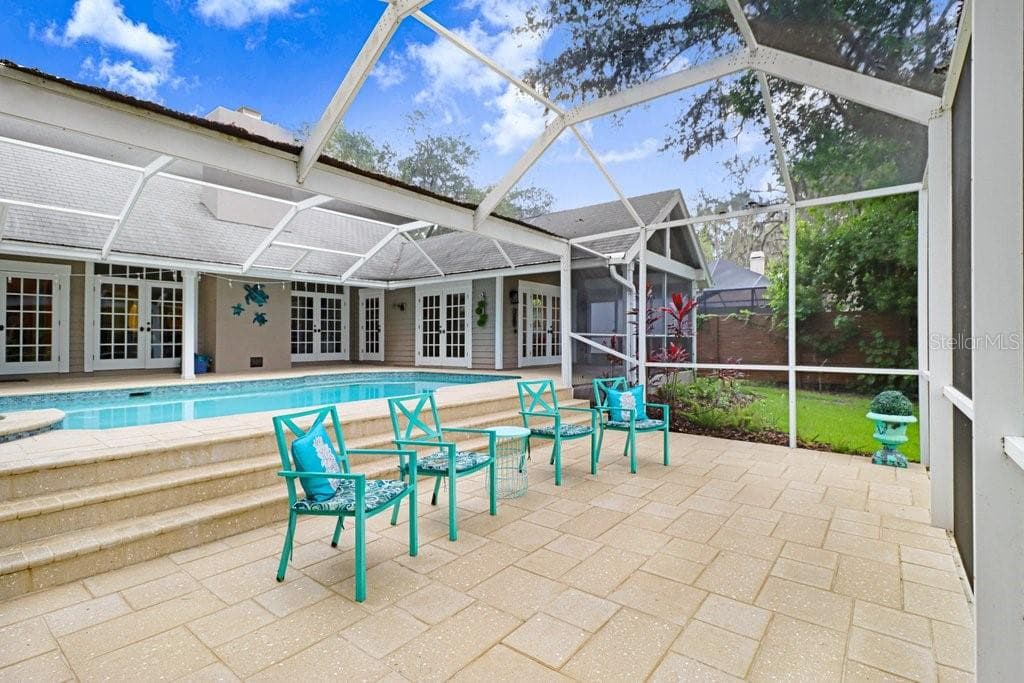 Step down patio area overlooking the backyard. - 1976 DUNLOE CIR, DUNEDIN