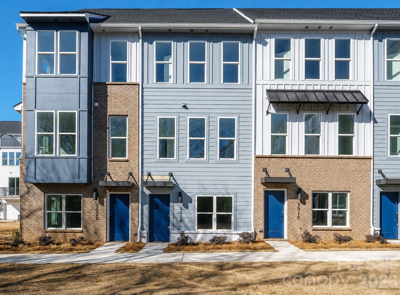 Modern four-level townhome featuring striking contemporary architecture, low-maintenance exterior finishes, and a prime Charlotte location close to shopping, dining, entertainment, and major commuter routes. - 3019 Jolene Court, Charlotte