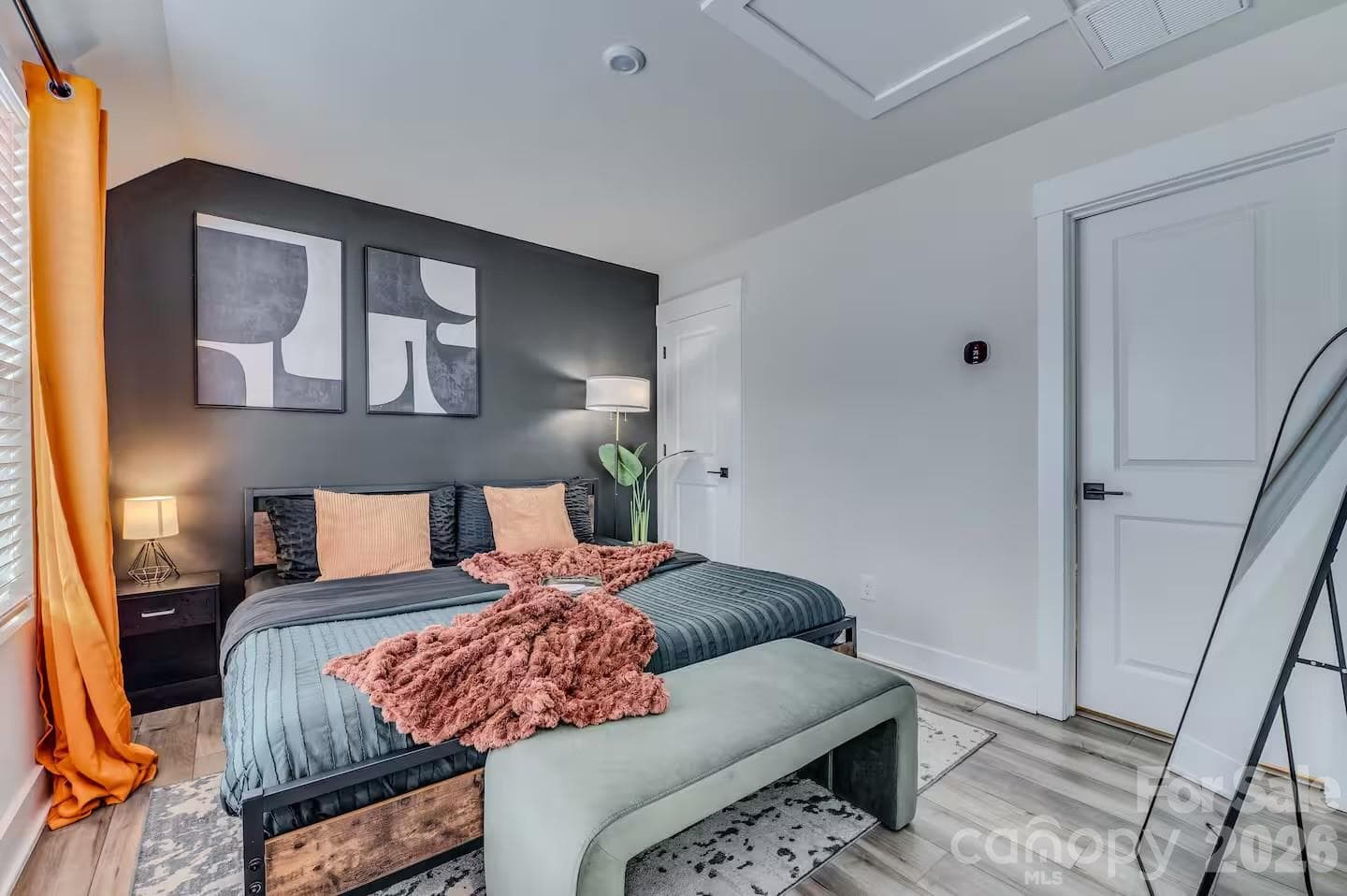 The spacious primary suite offers a peaceful retreat with abundant natural light, soaring ceilings, designer accent wall, and plenty of room to relax and unwind. - 3019 Jolene Court, Charlotte