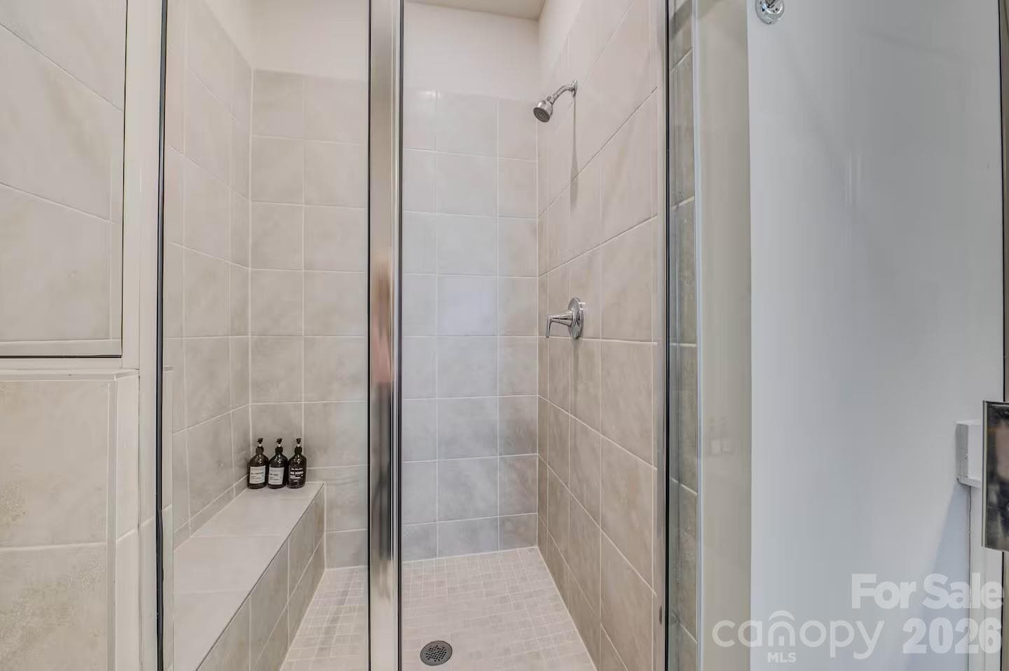 The spacious primary bathroom features a dual-sink vanity with ample counter space, modern finishes, and a large walk-in shower, creating a bright and relaxing retreat. - 3019 Jolene Court, Charlotte