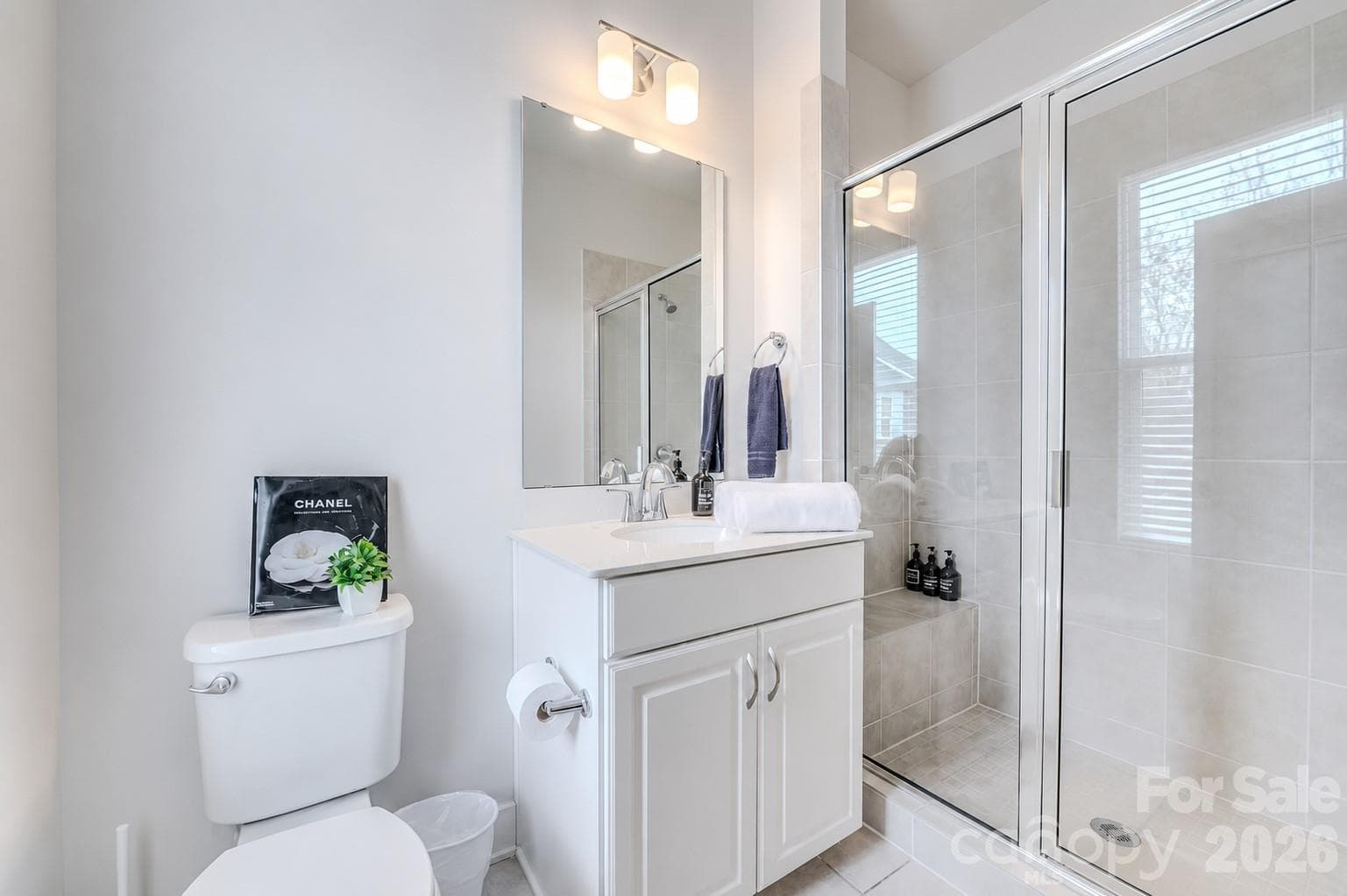 The stylish secondary bathroom features a spacious vanity, a tub/shower combination, and modern finishes, providing both comfort and functionality for family and guests. - 3019 Jolene Court, Charlotte