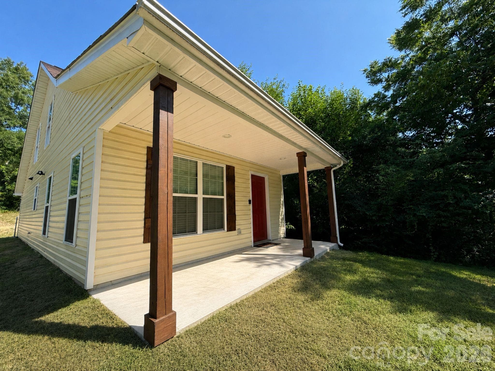 Front Exterior – Welcoming front elevation featuring a covered front porch with stained wood columns, low-maintenance vinyl siding, and a bold entry door for added curb appeal. - Chester
