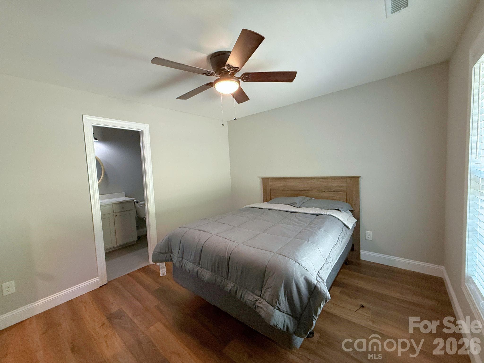 Primary Bedroom – Comfortable primary suite with a ceiling fan, large window, and direct access to the en-suite bathroom. - Chester