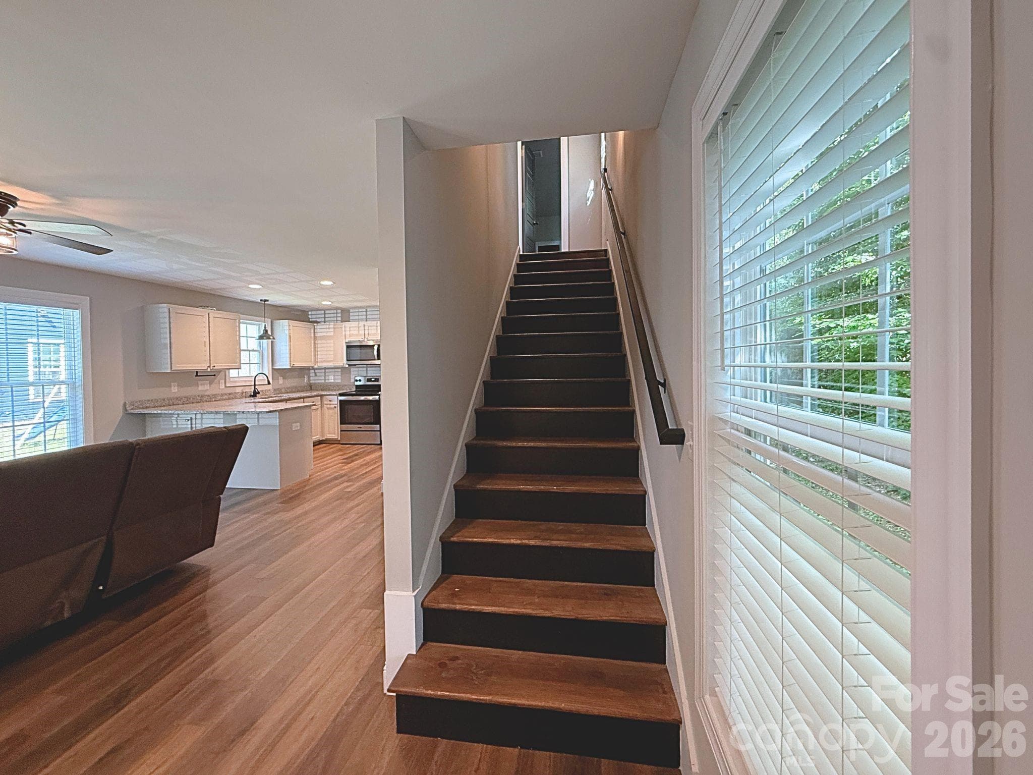 Staircase – Attractive staircase with wood treads and modern railing provides access to the upper level while complementing the home’s updated design. - Chester