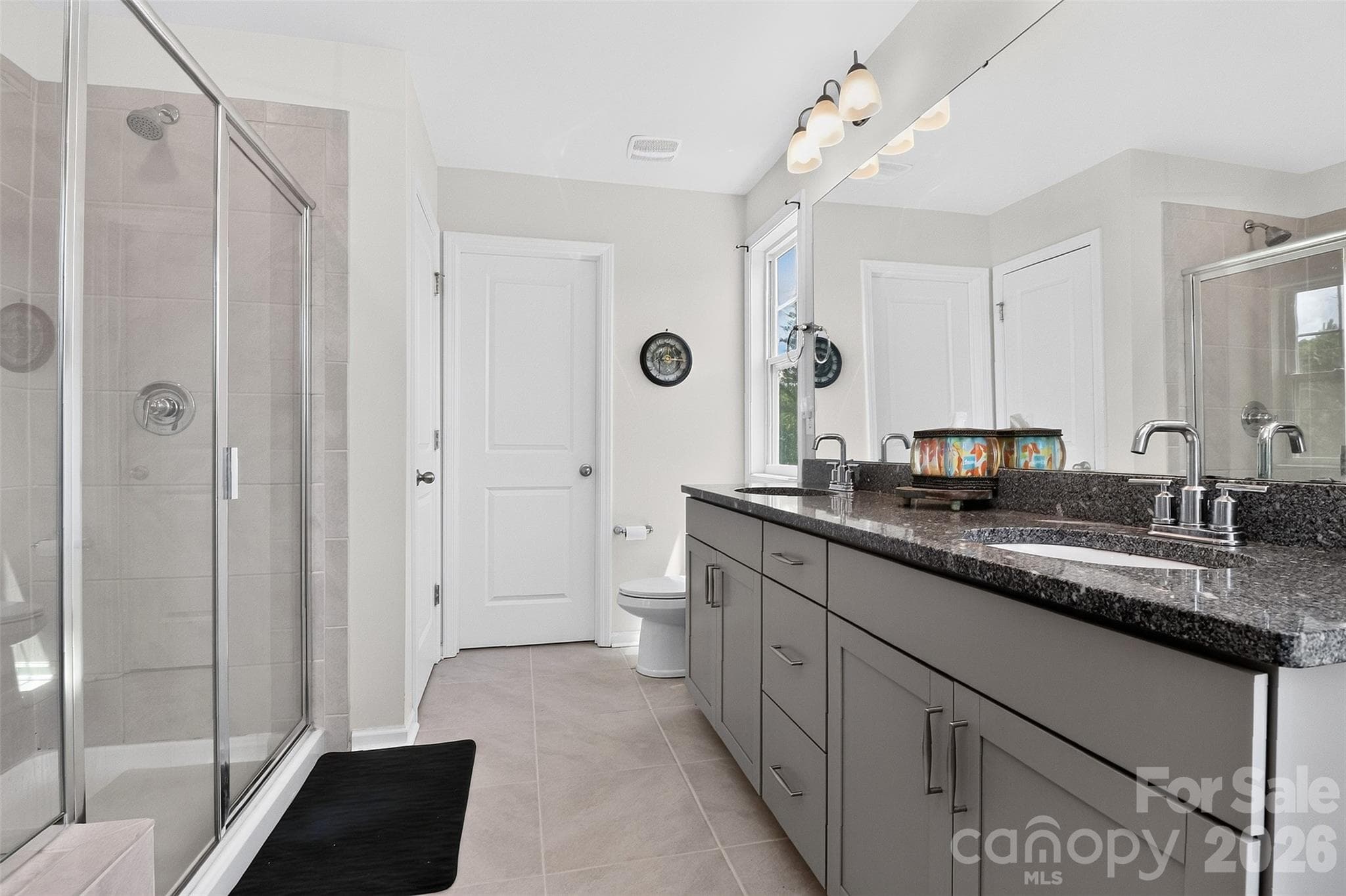 Modern primary bath with dual vanities, linen closet and walk-in closet - 1019 Chicory Trace, Clover
