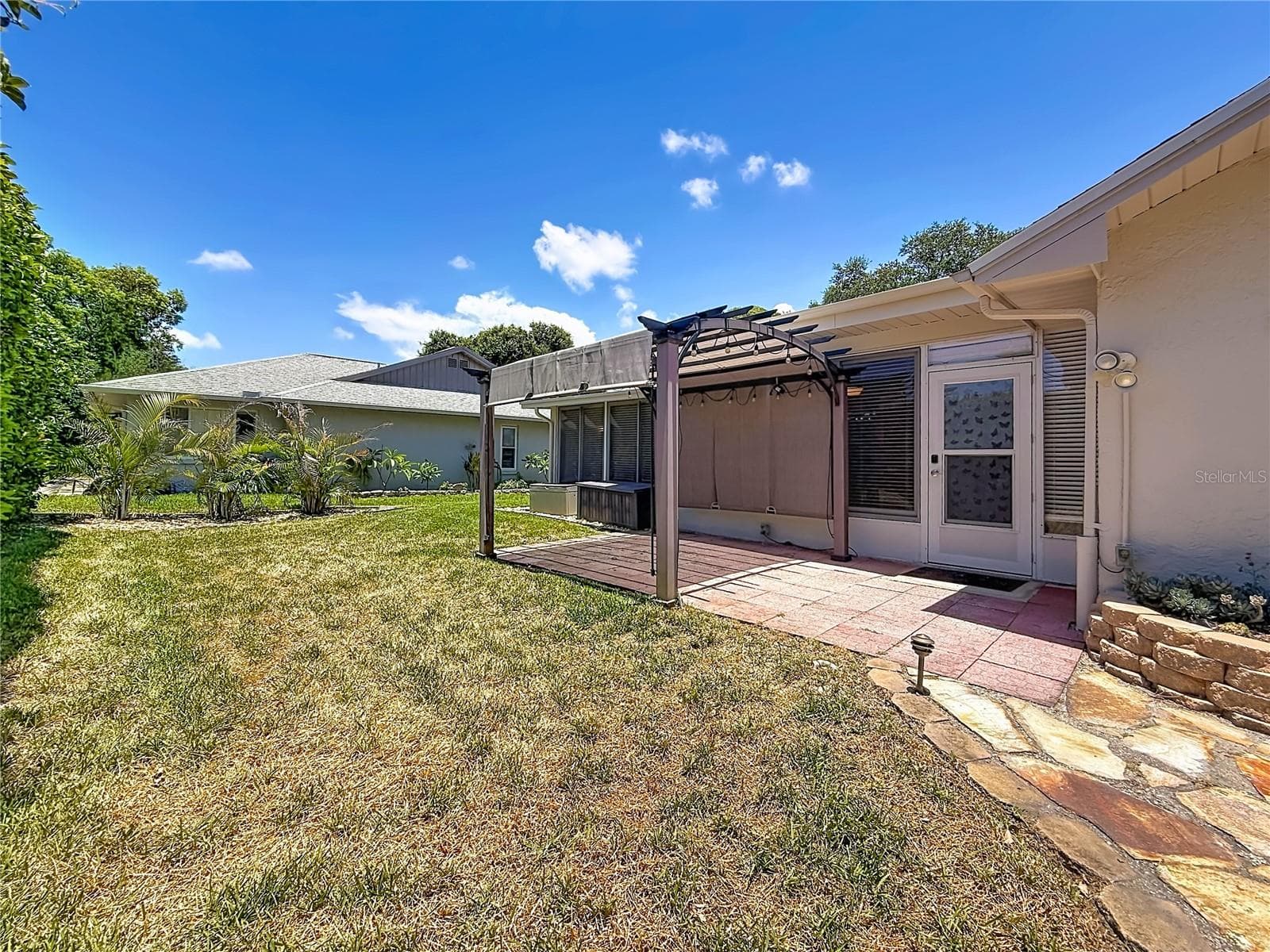 Pergola overlooking Rear Green Space - 2632 CAMILLE DR, PALM HARBOR