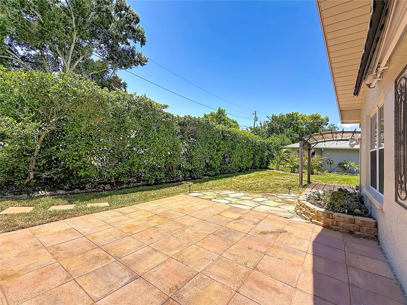 Patio overlooking Rear Green Space and Succulent Bed - 2632 CAMILLE DR, PALM HARBOR
