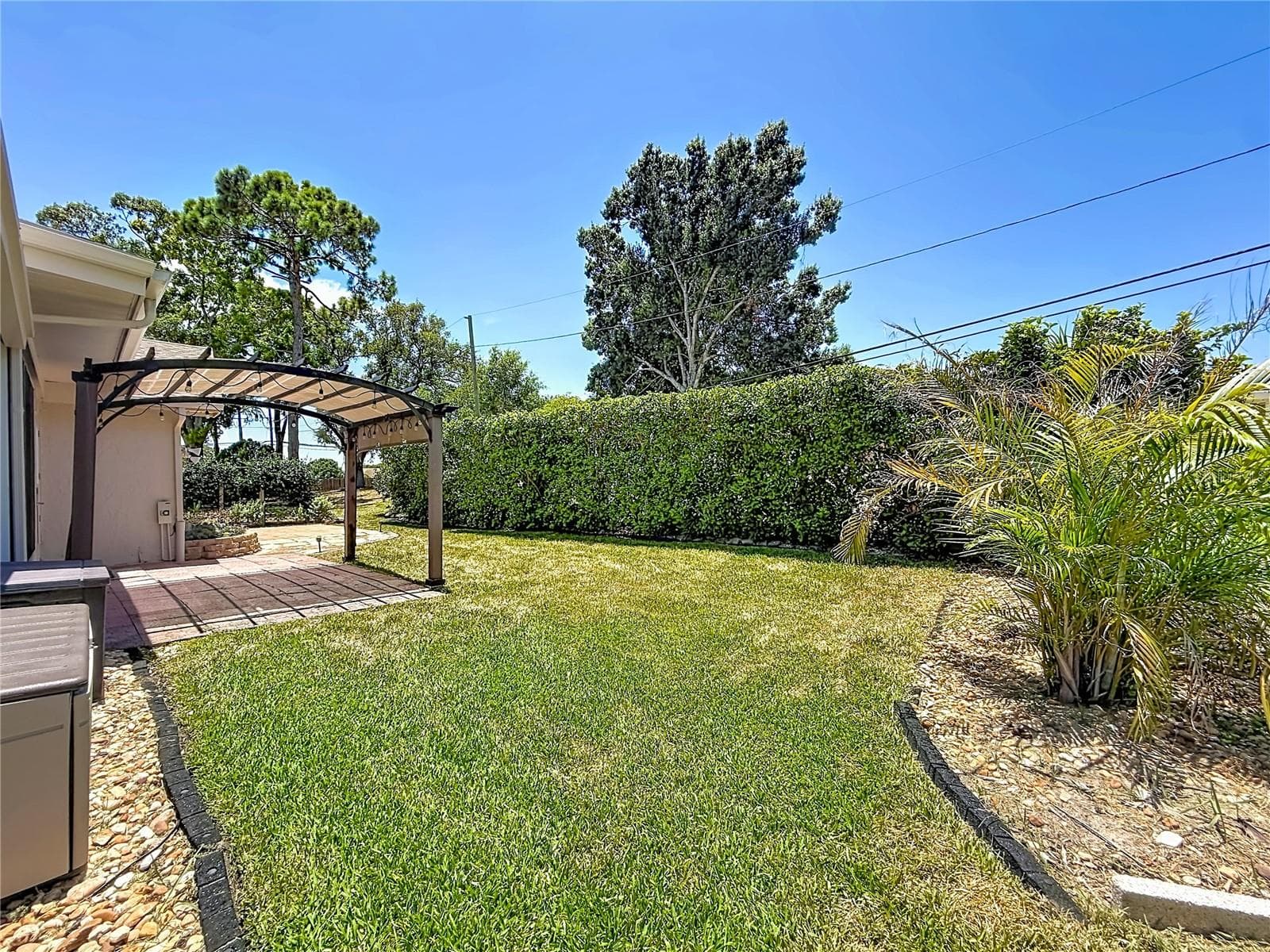 Rear Green Space and Outdoor Living Area - 2632 CAMILLE DR, PALM HARBOR