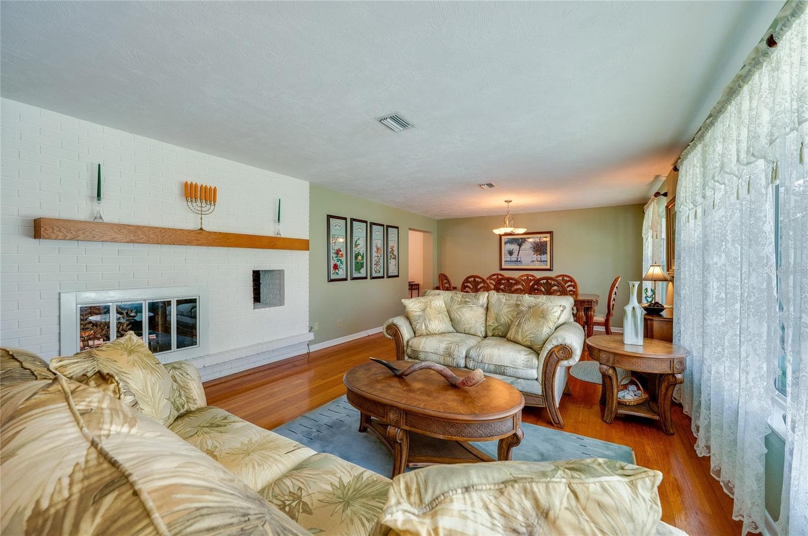 Living room with double-sided fireplace - 697 JOHN ANDERSON DR, ORMOND BEACH