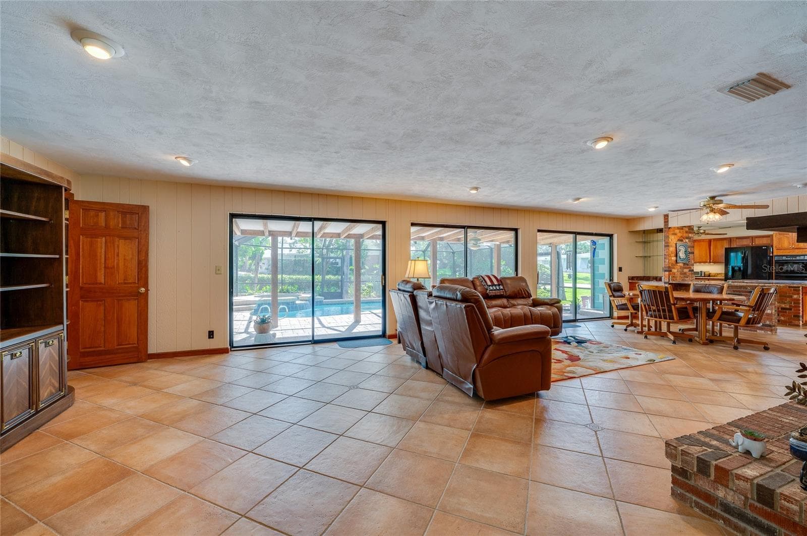 Family room with breakfast area and kitchen on right - 697 JOHN ANDERSON DR, ORMOND BEACH