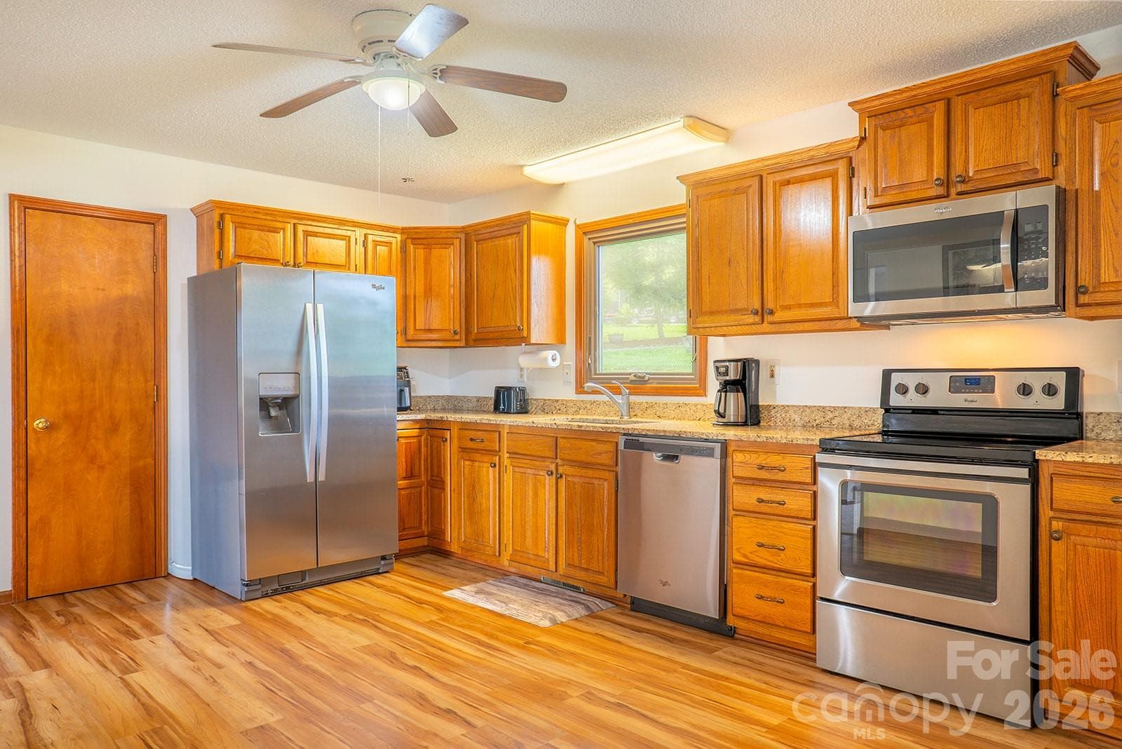 Stainless appliances and large picture window over the sink - 100 Forest Park Drive, Hendersonville