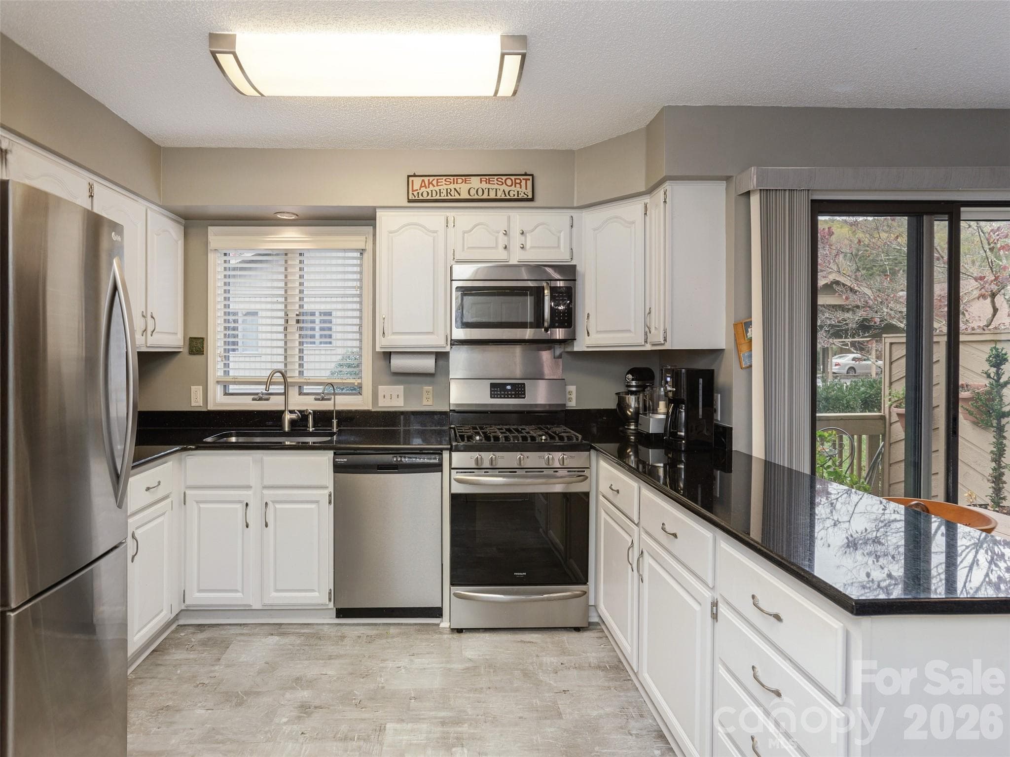 Gas stove and microwave, newer lighting to match - 606 Red Oak Drive, Hendersonville