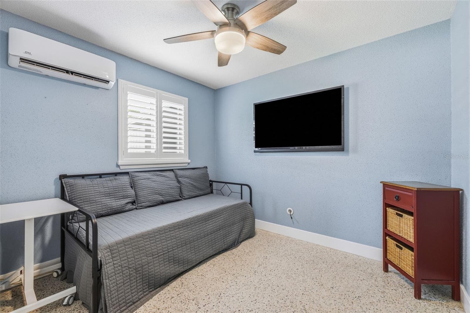 Secondary bedroom features polished Terrazzo flooring, plantation shutters, ceiling fan, mini-split HVAC system with remote. - 4320 FLORAMAR TER, NEW PORT RICHEY