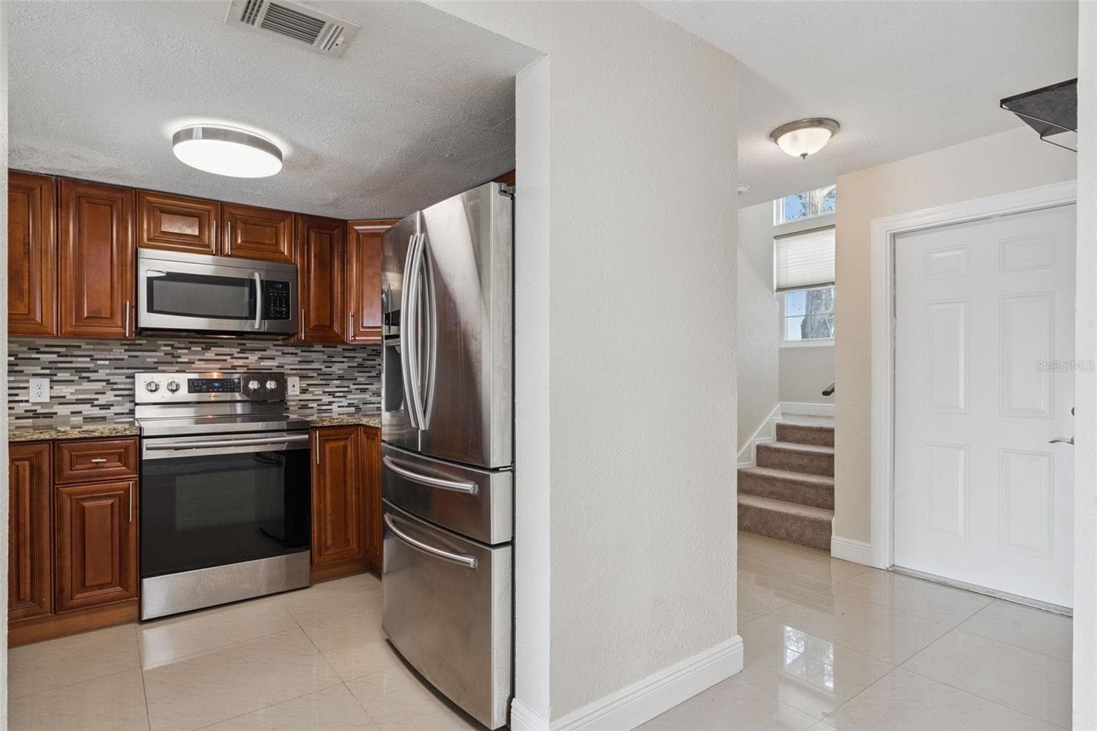 Kitchen with Granite Countertops and new Stainless Steel Appliances - 214 MAJORS LN #C, KISSIMMEE