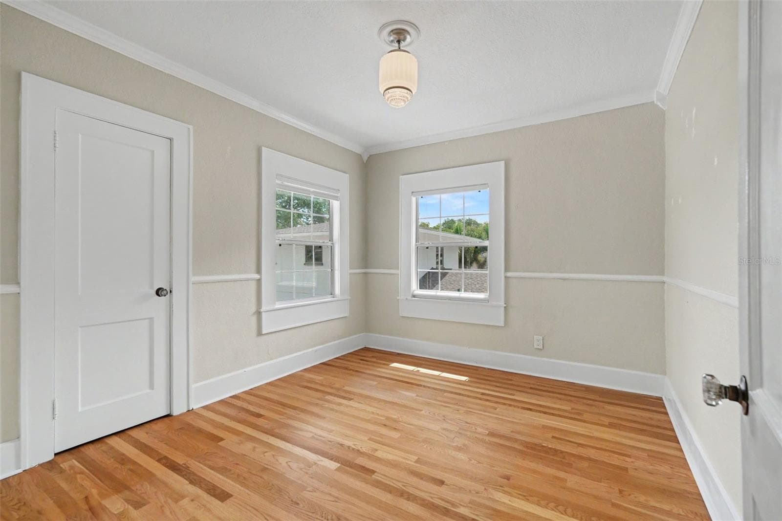 A charming upstairs bedroom offers natural light, classic trim, and the versatility to fit a variety of needs. - 857 21ST AVE N, ST PETERSBURG
