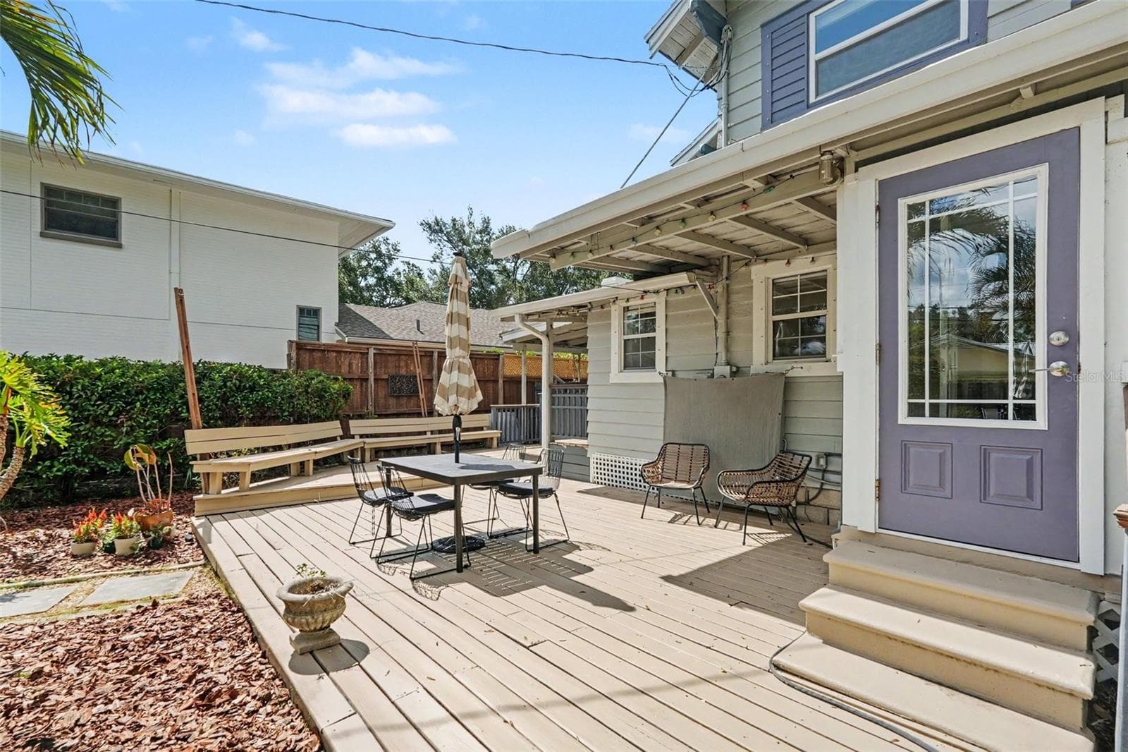 Another view of the expansive deck highlights the multiple seating areas and easy connection between the home and backyard. - 857 21ST AVE N, ST PETERSBURG