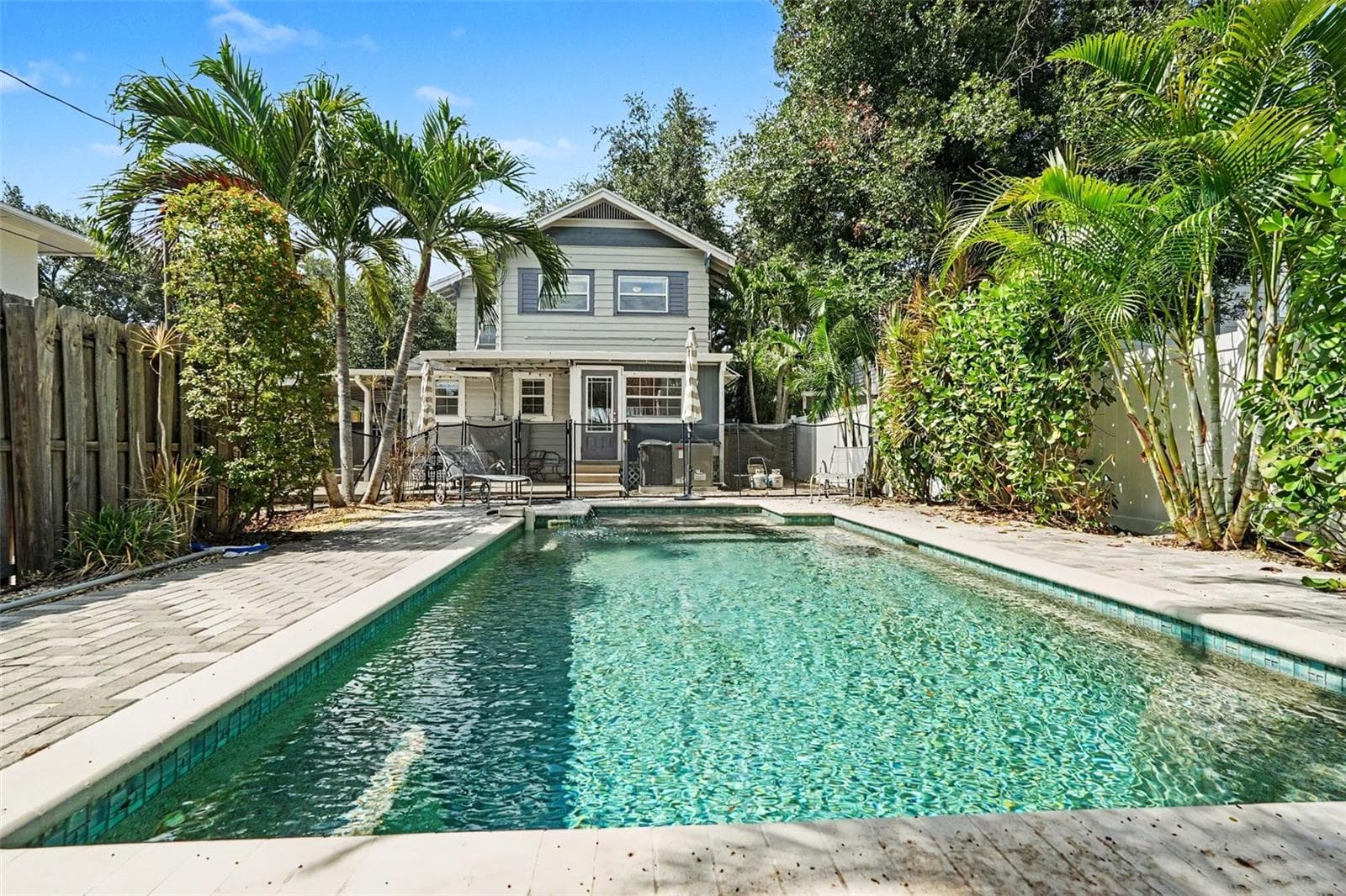 Looking back toward the home, the pool and surrounding patio showcase the property’s inviting indoor-outdoor lifestyle. - 857 21ST AVE N, ST PETERSBURG