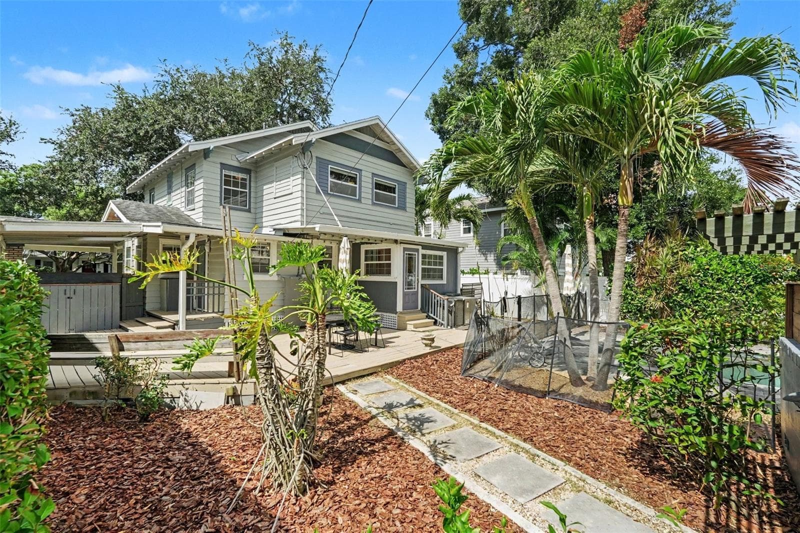 The backyard offers more than just a pool, with tropical landscaping, garden space, and multiple outdoor areas to enjoy. - 857 21ST AVE N, ST PETERSBURG