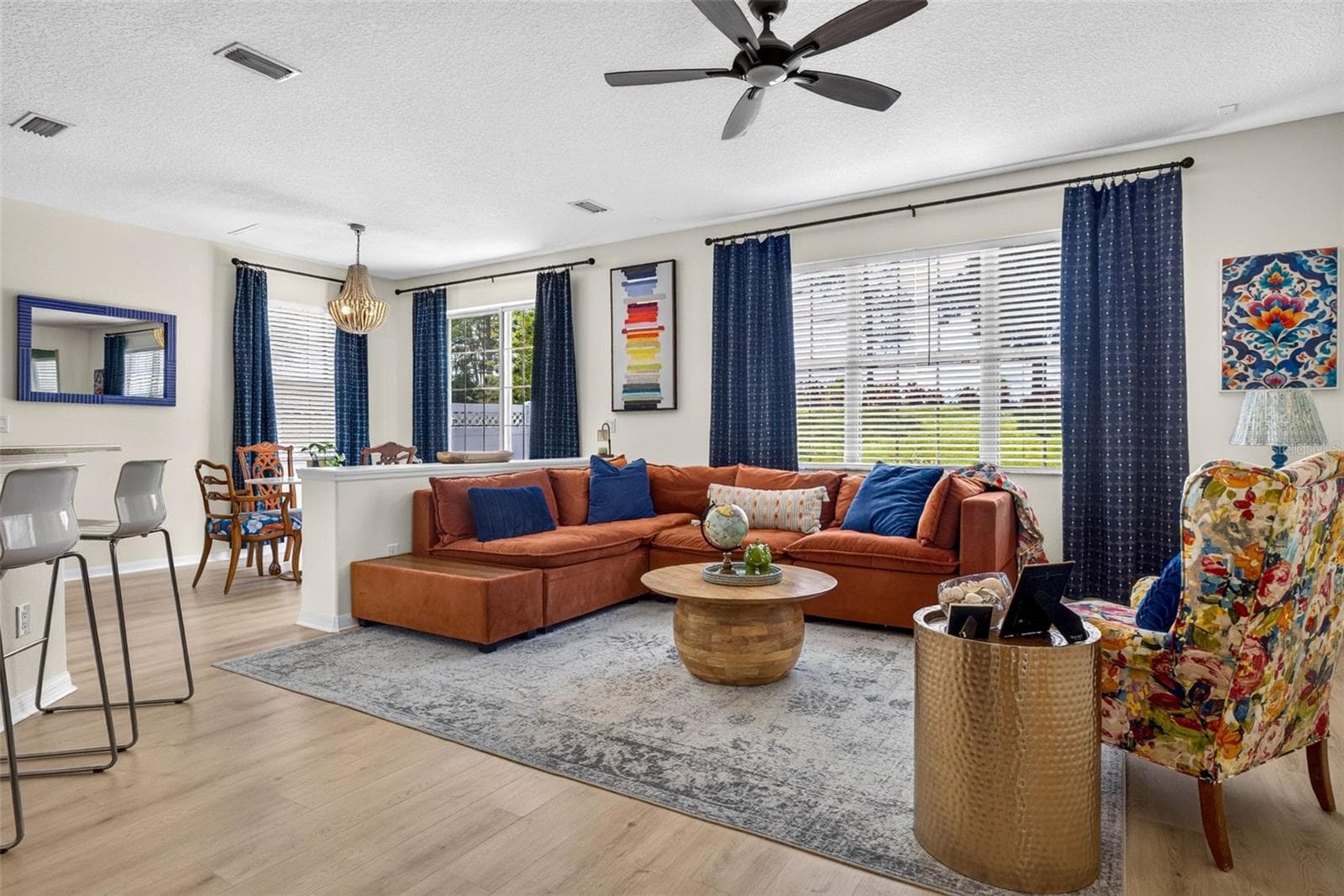 Living room fits large sectional with views of the backyard - 7360 BRIDGEVIEW DR, WESLEY CHAPEL