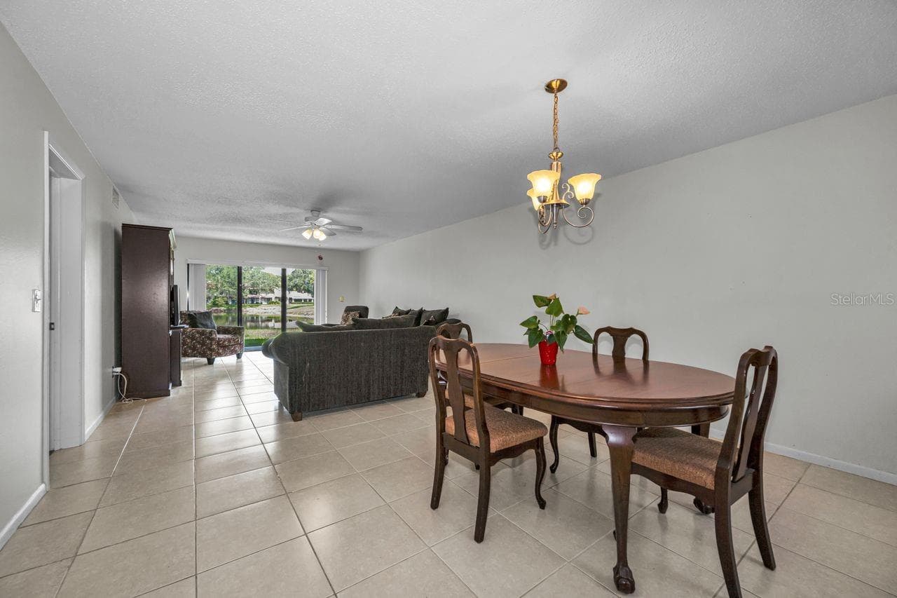 living room and dining w/pond view - 3505 TARPON WOODS BLVD #O-403, PALM HARBOR