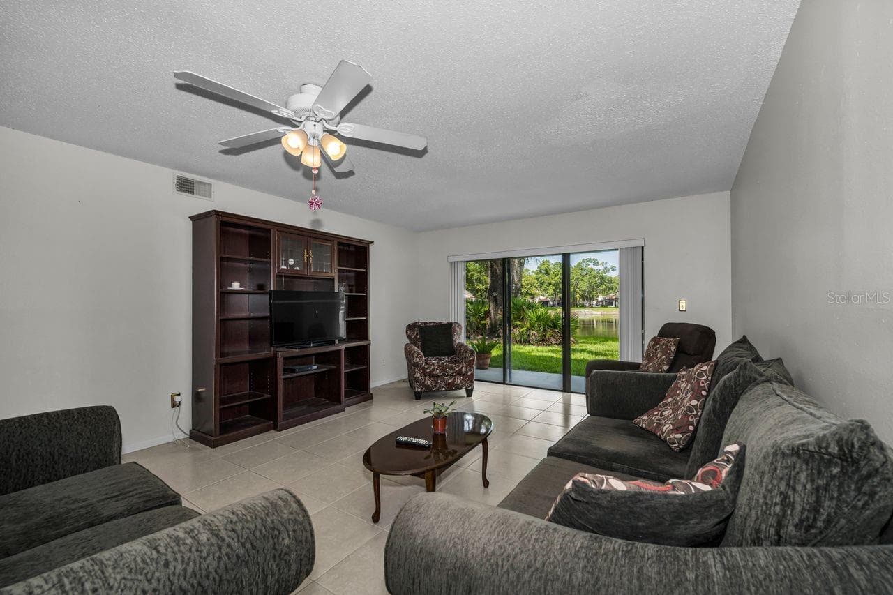 living room w/pond view - 3505 TARPON WOODS BLVD #O-403, PALM HARBOR