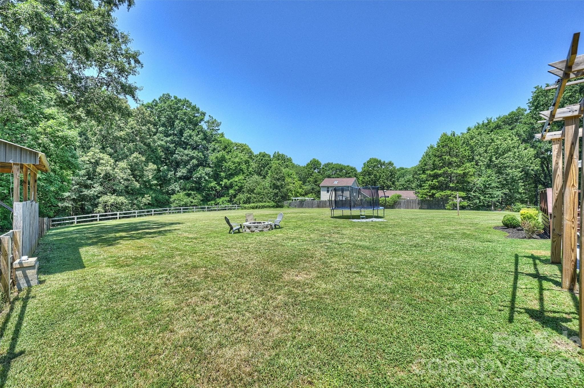 Welcome Home: Large 2.38 acre backyard and extended covered parking area and attached garage, Pergola outdoor living space, deck and patio area - 10943 Harrisburg Road, Indian Land