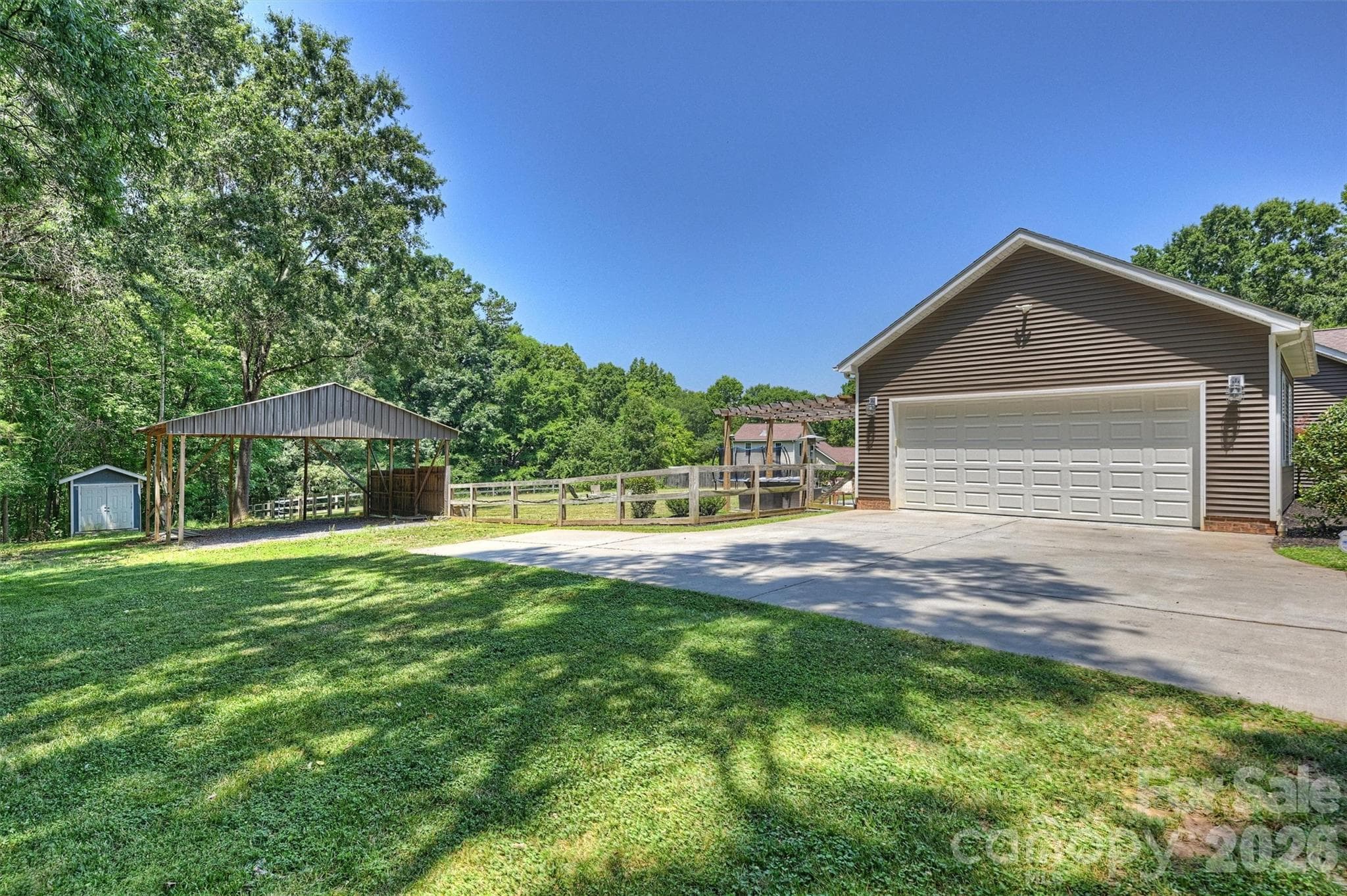 Loads of parking opportunity. In addition to the carport that may be converted to an equestrian stable, there is also large gravel parking space that makes this a perfect estate for entertaining. - 10943 Harrisburg Road, Indian Land