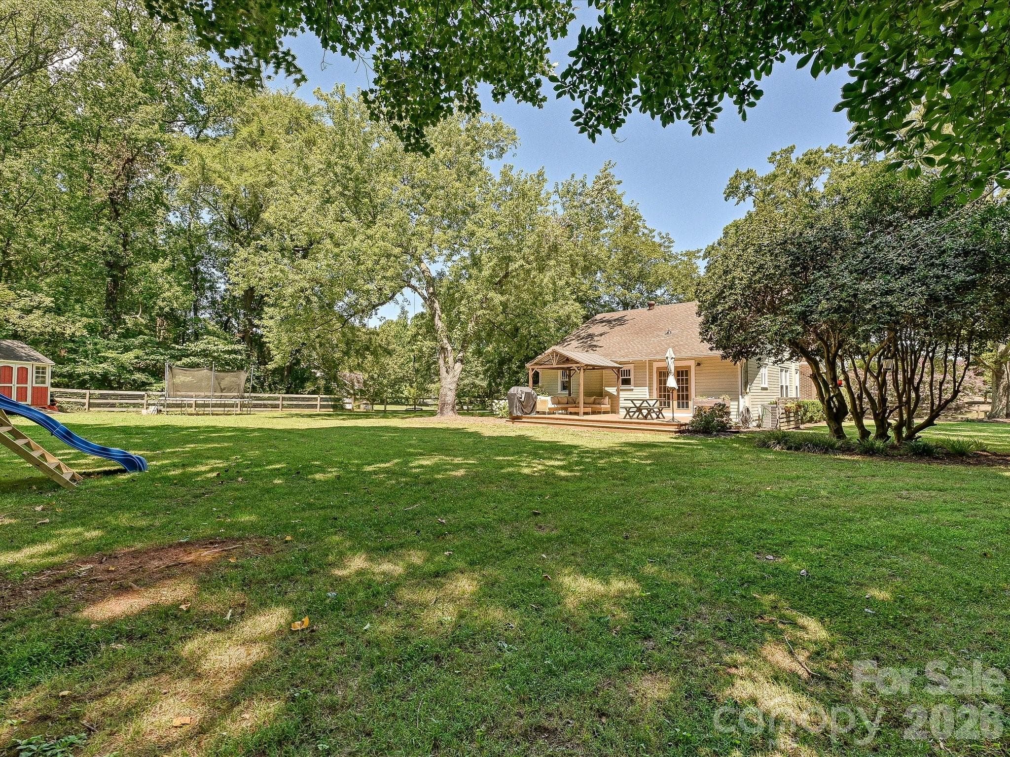 Enjoy peaceful outdoor living with a spacious deck overlooking the private backyard, perfect for gatherings or quiet evenings at home. - 3514 Kelly Road, Charlotte