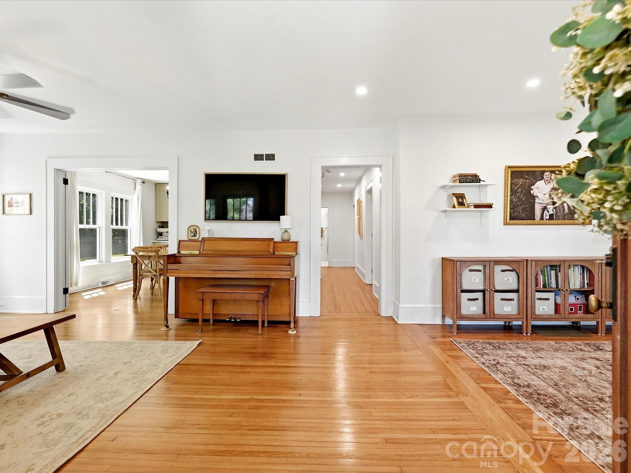 Step inside to a bright and inviting living room featuring beautiful hardwood floors, abundant natural light, and seamless flow into the home's main living spaces. - 3514 Kelly Road, Charlotte