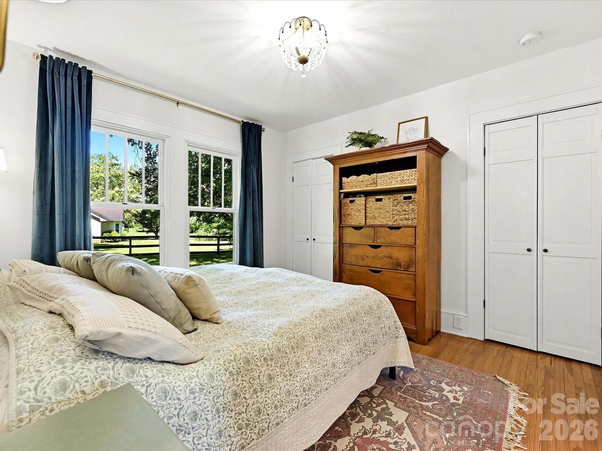 The serene primary suite offers generous natural light, hardwood floors, and direct access to a beautifully updated en-suite bathroom. - 3514 Kelly Road, Charlotte