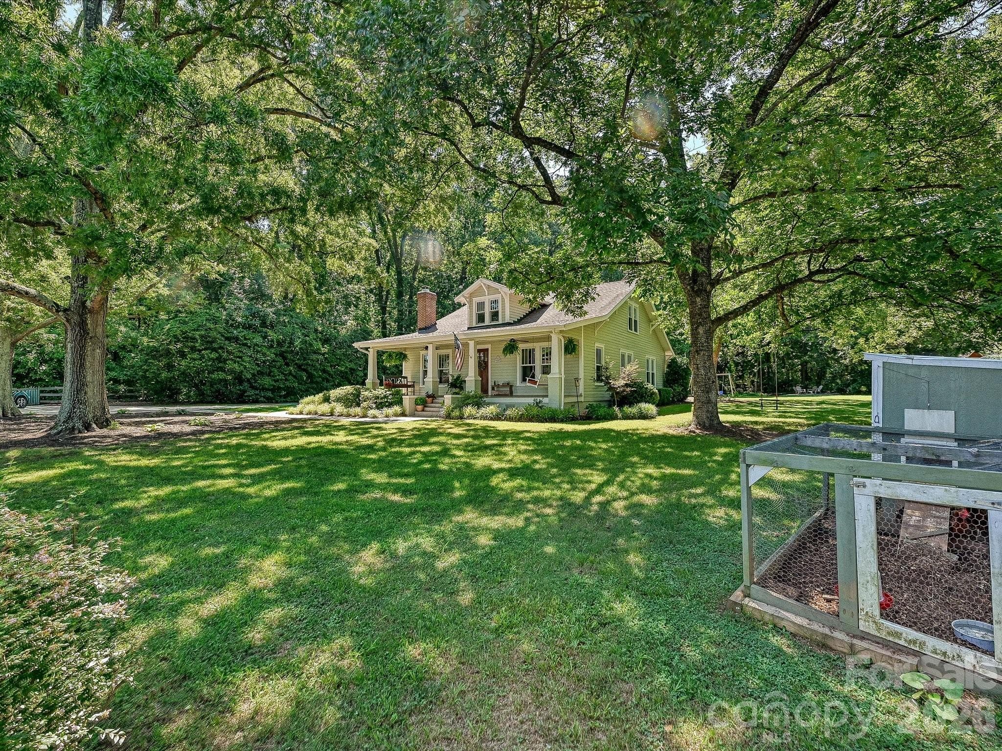 Nestled beneath mature shade trees on a picturesque homesite, this timeless home offers exceptional curb appeal and a peaceful country setting. - 3514 Kelly Road, Charlotte