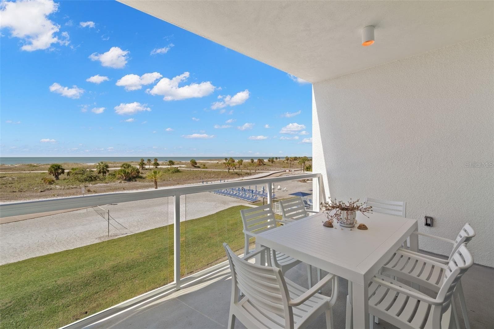 This fully furnished, turnkey 2-bedroom, 2-bath coastal retreat features marble flooring throughout the main living area, full-size in-unit washer/dryer, sleeper sofa, designer lighting, and a crisp, modern aesthetic that consistently attracts top-tier bookings. Unit 304 is already a leader at the Ocean Club, achieving one of the highest occupancy rates with future reservations continuing to fill rapidly. - 11500 GULF BLVD #304, TREASURE ISLAND