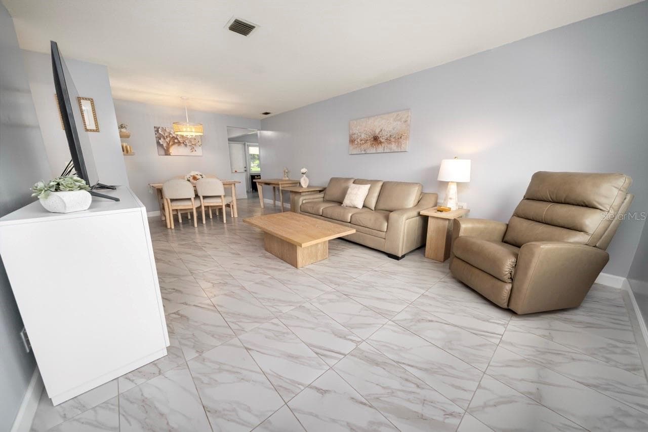 FAMILY ROOM. THIS VILLA STYLE CONDO IS PERFECT FOR ENTERTAINING FAMILY AND FRIENDS - 8235 BURGUNDY DR N #3, PINELLAS PARK